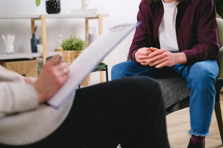 Therapist and client discussing issues in a psychotherapy session, highlighting mental health support.